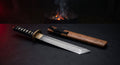 Damascus tanto knife with a raindrop pattern blade, angular chisel point and a wooden oiled rosewood saya