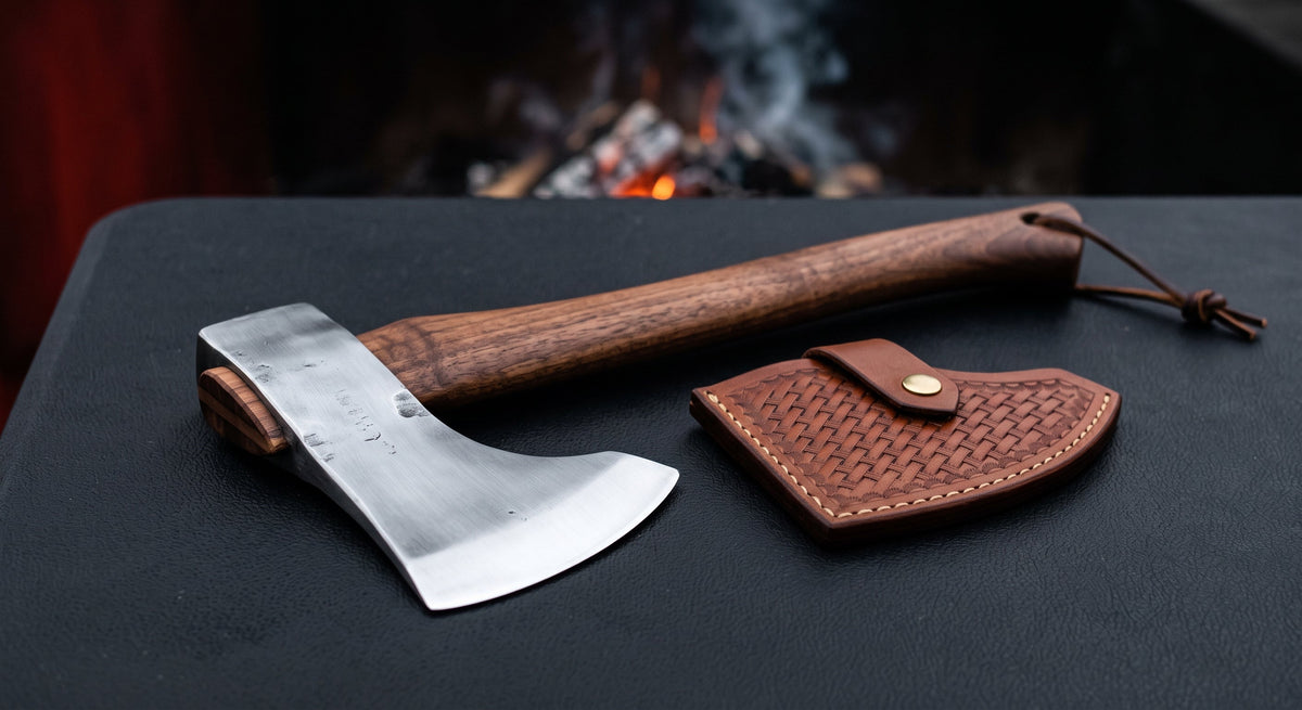 Hand forged throwing axe with a bearded head, 16 inch walnut handle and a stamped leather cover