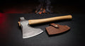 Damascus throwing hatchet with a raindrop pattern head, hickory handle and a stamped leather cover