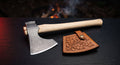 Damascus throwing axe with a bearded raindrop pattern head, ash handle and a hand carved leather cover