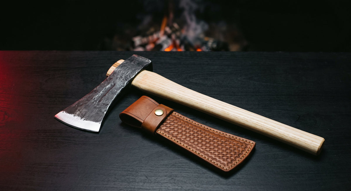 Hand forged tomahawk with a 19 inch ash handle, hammer poll and a stamped leather head cover