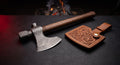 Damascus tomahawk with a twist pattern head, walnut handle and a hand carved leather head cover