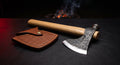 Hand forged tomahawk with a round poll, 19 inch oak handle and a stamped leather head cover