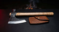 Hand forged tomahawk with a hammer poll, curly maple handle and a stamped leather head cover
