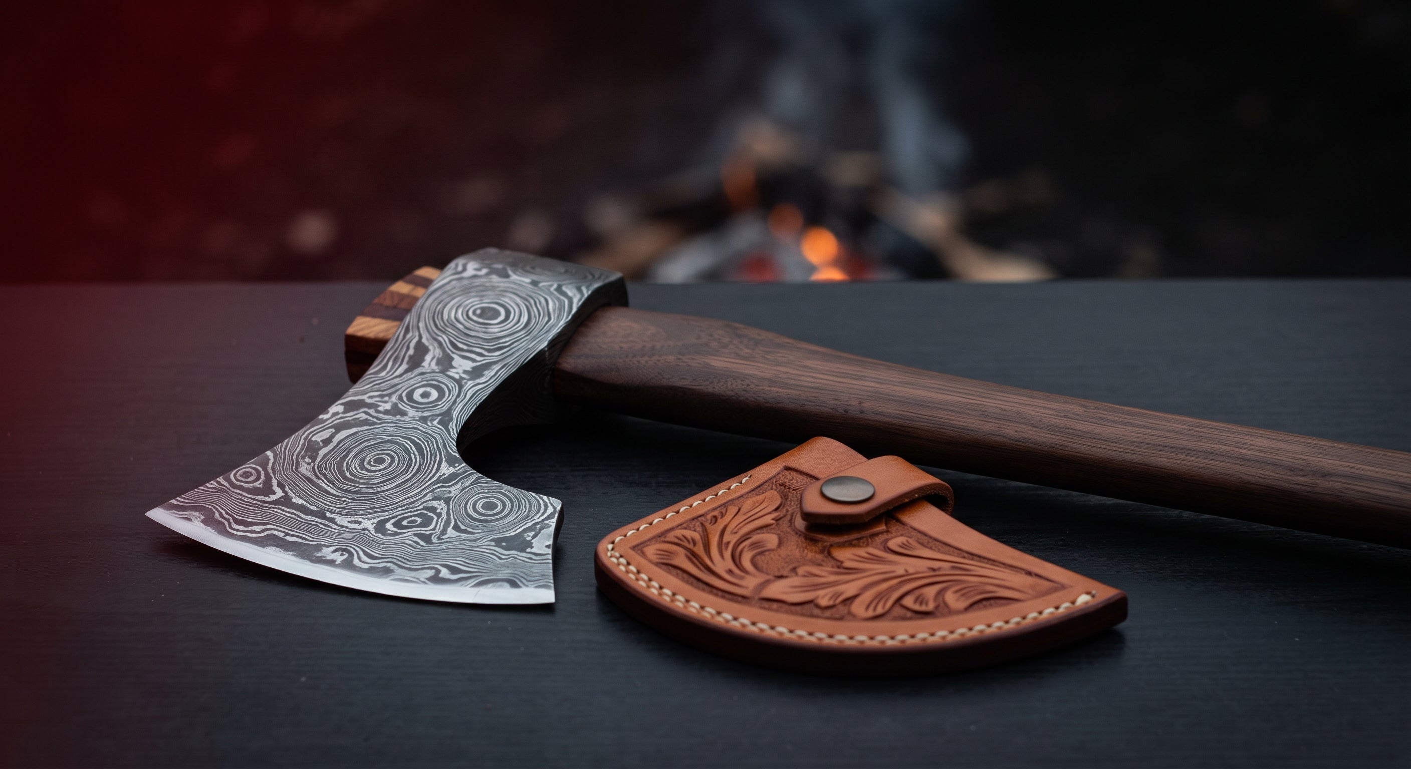 Damascus viking hand axe with a raindrop pattern head, walnut handle and a hand carved leather head cover