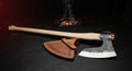 Hand forged long hafted viking axe with a wide thin head, 40 inch ash handle and a stamped leather cover