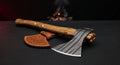 Damascus viking axe with a ladder pattern head, olive wood handle with spiral brass wire inlay and a hand carved cover